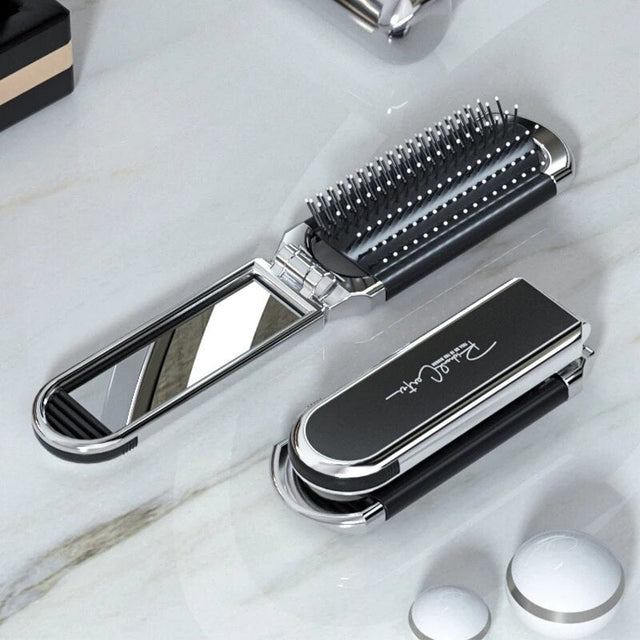 Compact hairbrush with integrated mirror |