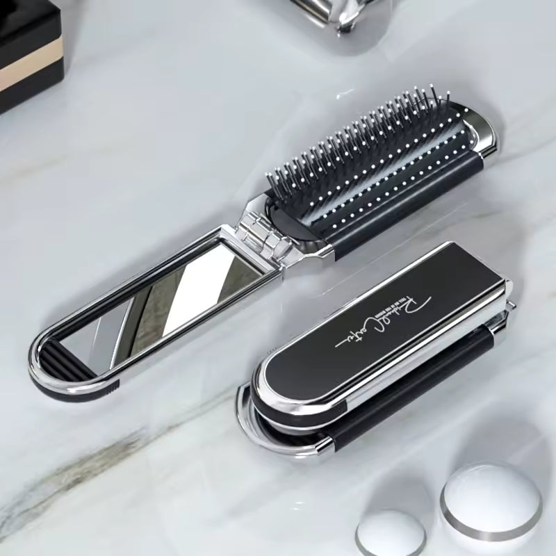 Compact hairbrush with integrated mirror |