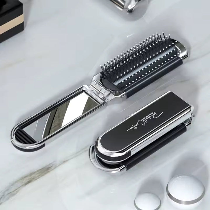Compact hairbrush with integrated mirror |