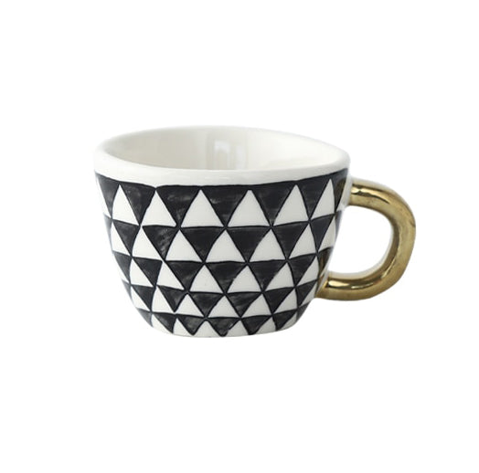 Cup with abstract geometric pattern and gold handle