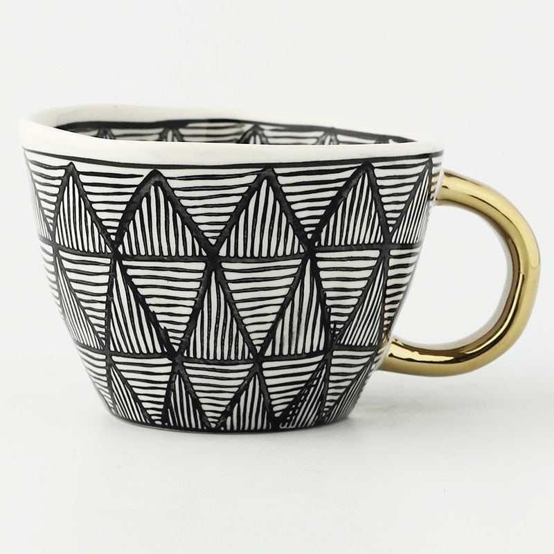 Cup with abstract geometric pattern and gold handle