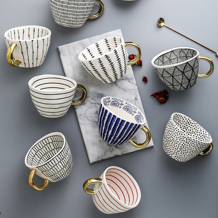 Cup with abstract geometric pattern and gold handle