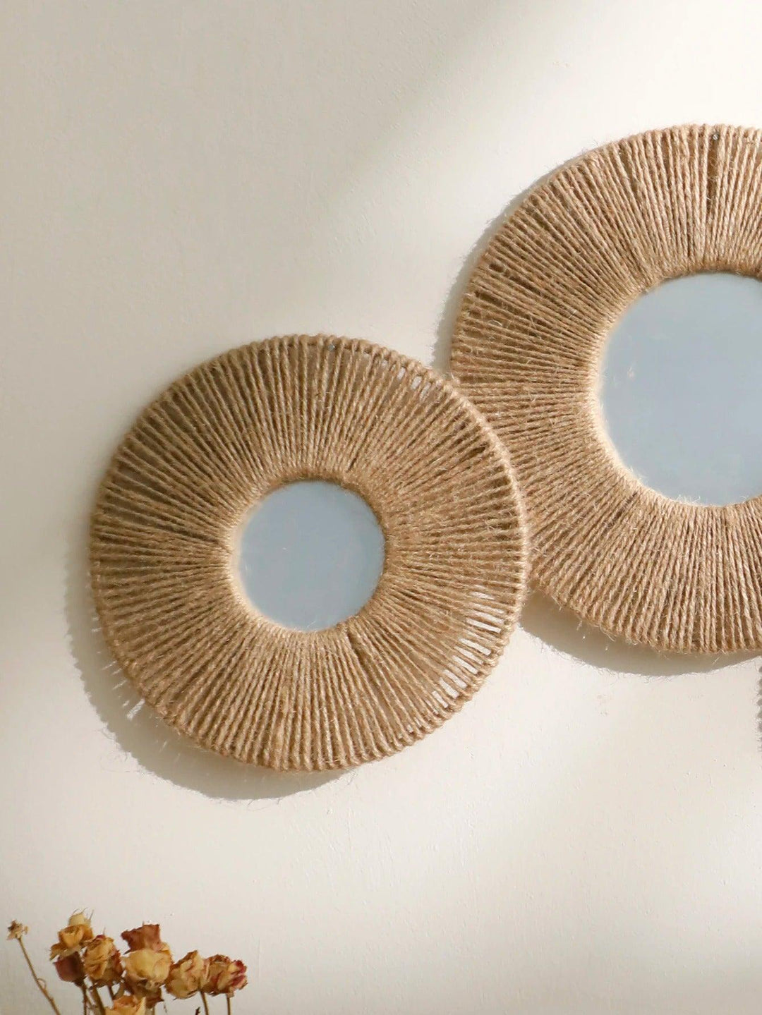 Round decorative wall mirror in boho style with woven hemp rope