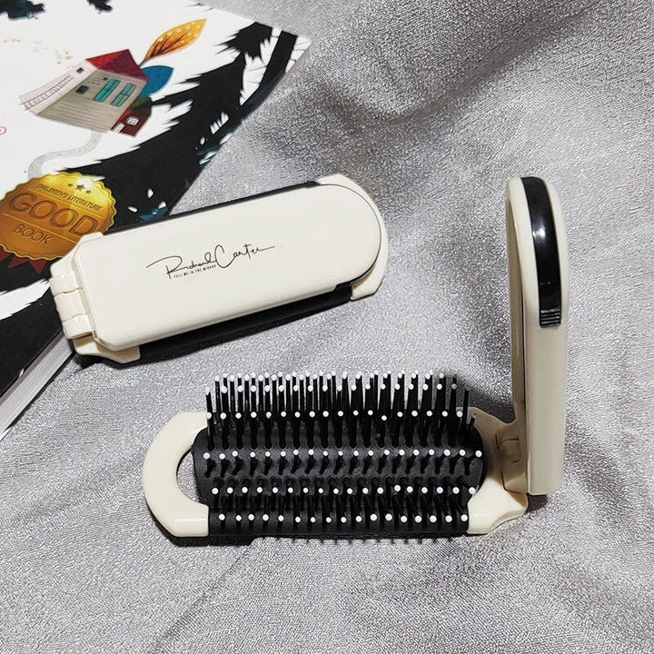 Compact hairbrush with integrated mirror |