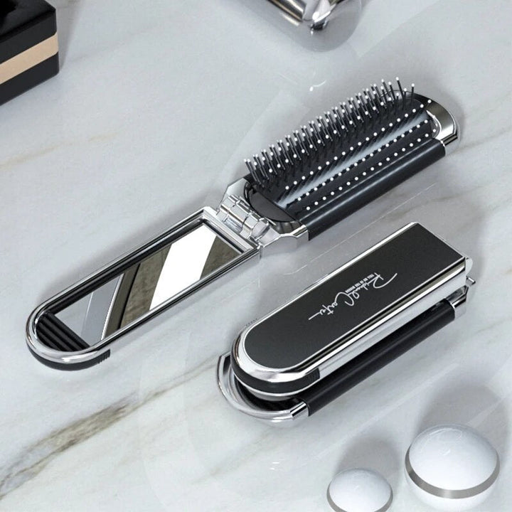 Compact hairbrush with integrated mirror |