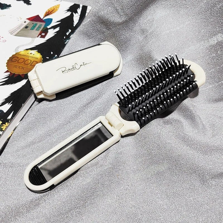 Compact hairbrush with integrated mirror |
