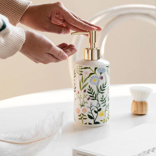 Soap dispenser made of ceramic with floral design